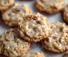 there are many cookies with icing on the top and one cookie has pecans