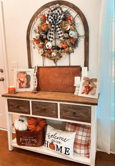 the entryway is decorated for fall with pumpkins and other decorations