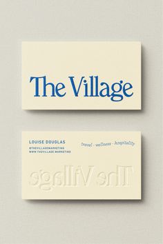 two business cards with the village logo on them