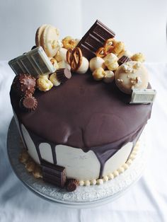 a chocolate cake topped with lots of different types of candies and other things on top of it