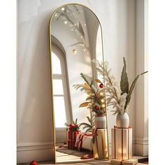 a large mirror sitting on top of a table next to a vase filled with flowers