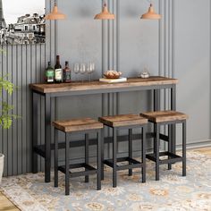 three stools and a table with bottles on it in front of a wall mounted mirror