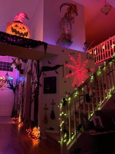 halloween decorations are lit up on the stairs in this home's entryway area