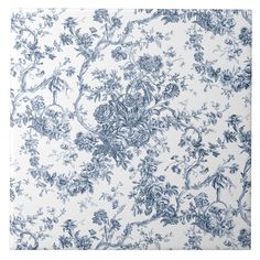 a blue and white wallpaper with flowers on it