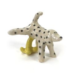 a ceramic dalmatian dog figurine with black dots