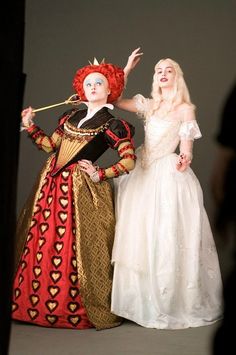 two women dressed in costume standing next to each other