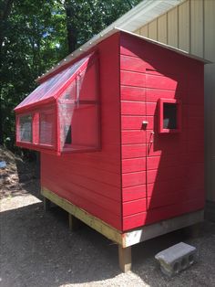 a small red building with a metal roof