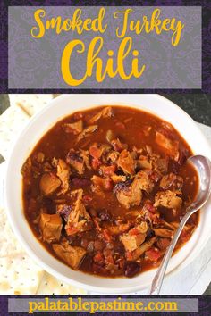 a bowl of smoked turkey chili with tortilla crackers in the background and text overlay that says smoked turkey chili