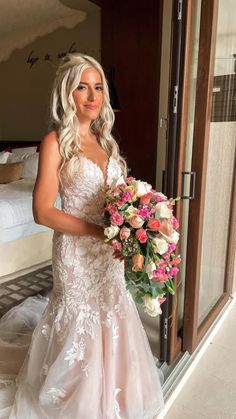 a woman in a wedding dress holding a bouquet