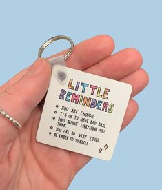 someone is holding a keychain that says little reminders