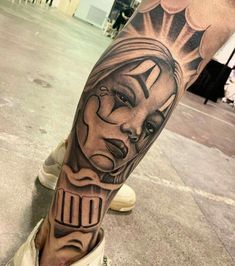 a man's leg with a tattoo on it that has an image of a woman