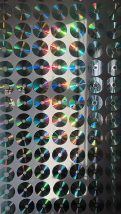 the window is covered with many different colored cds on it's glass coverings