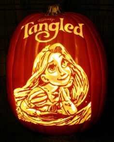 a pumpkin carved to look like a girl with long hair and the words tangled on it