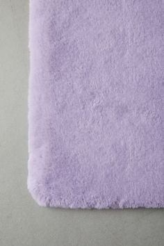 a close up of a purple rug on a white surface with no one in it