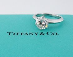 a diamond ring sitting on top of a tiffany and co book with the title tiffany & co