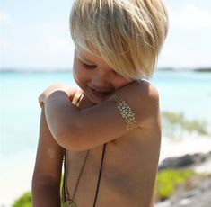 a little boy with tattoos on his back