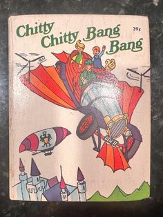 an old children's book with cartoon characters flying in the sky on top of it