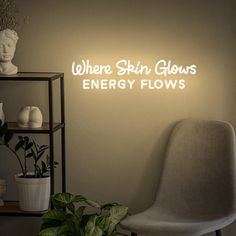 there is a neon sign that says where skin glows energy flows on the wall