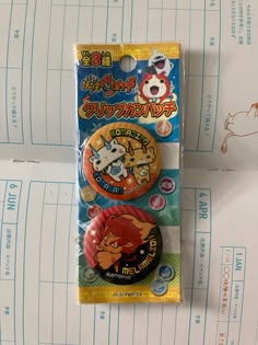 two badges are sitting on top of a piece of paper