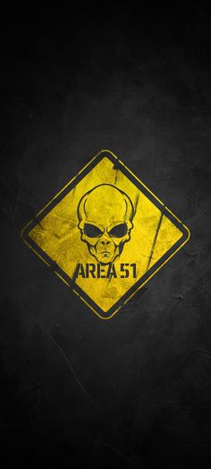 a yellow area 51 sign with a skull on it