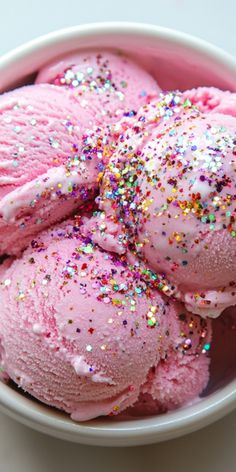 pink ice cream with sprinkles in a bowl