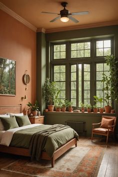 a bedroom with green walls and plants in the window sill, along with a bed