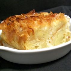 a close up of a piece of food in a bowl on a black table cloth