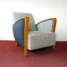 a chair sitting on top of a red carpeted floor next to a white wall