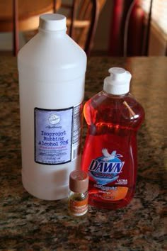 a bottle of dish soap next to a container of mouthwash