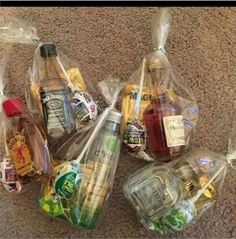 several plastic bags filled with food and condiments sitting on the floor next to each other