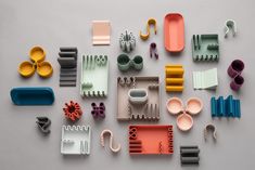 an assortment of kitchen utensils and accessories laid out on a gray surface, top view