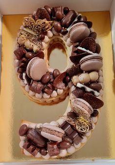 a cake shaped like the number nine with chocolates and marshmallows