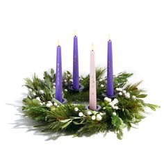 a wreath with purple candles and greenery