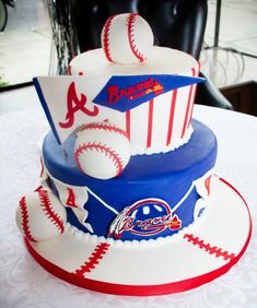 a three tiered cake with baseballs on it