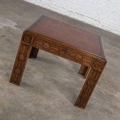 a wooden table sitting on top of a cement floor