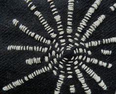 a black and white rug with an intricate design