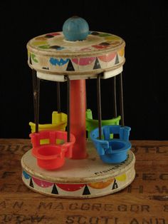 an old toy carousel with plastic cups on it