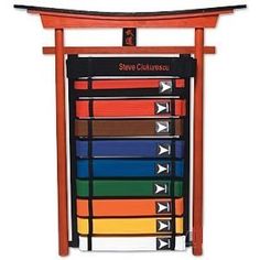 an orange wooden display case with seven different colored belts on it's sides and the words show culture