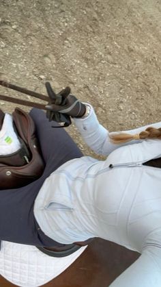 a woman riding on the back of a brown horse