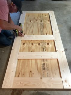 a man is working on some wood planks that are being made into a table