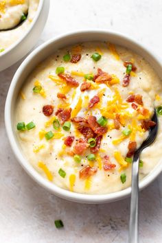 two bowls of potato soup with bacon and cheese