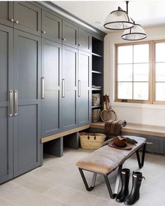 a bench sitting in the middle of a room with lots of cupboards on it