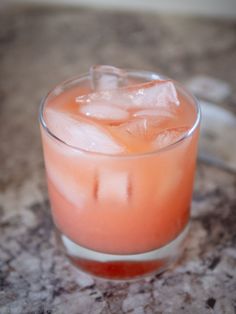 a close up of a drink in a glass on a table