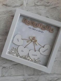 a white frame with some hearts and words in the shape of heart on top of it