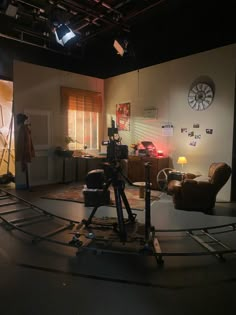 a camera set up in the middle of a room with chairs and lights on it