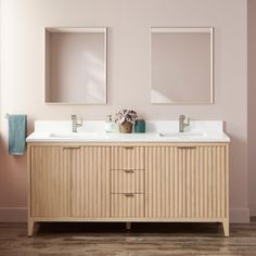 a bathroom with two sinks and mirrors on the wall next to each other in front of a pink wall