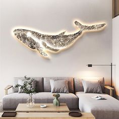 a living room filled with furniture and a large wall mounted whale on it's side