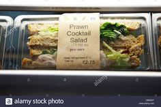 a display case in a deli filled with sandwiches and salads