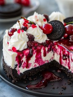 a piece of cheesecake with cherries and oreo cookies on top is sitting on a plate