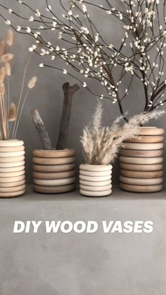 vases are stacked on top of each other with branches in them